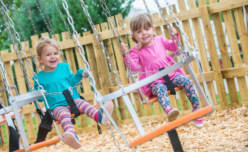 Two kids on swing ride at Avon Valley Adventure and Wildlife Park